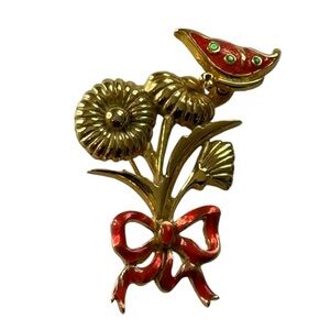 Gold tone brooch with red enamel and green stones